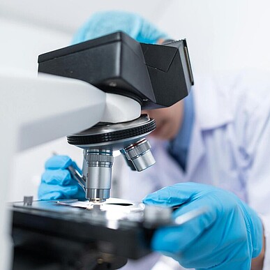 Person mit einem Mikroskop